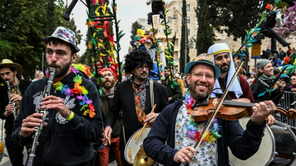 Smiling through tears: Hostage families lead Jerusalem Purim parade