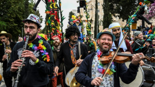 Smiling through tears: Hostage families lead Jerusalem Purim parade