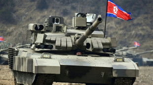 N. Korean leader unveils and 'drives' new battle tank